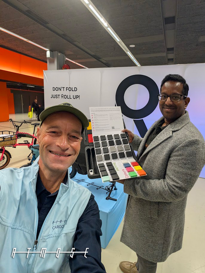 Two ATMOSE team members with the colour sample board at the ICBF 2026 stand